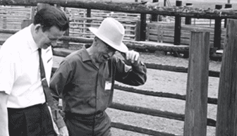 President Robert MacVicar walks with rancher Lloyd Smith, July 1970