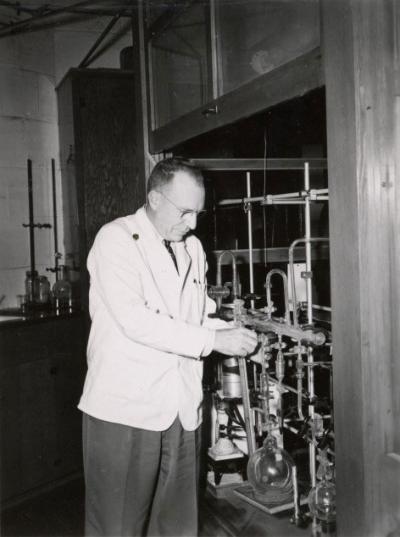 <p>Dr. Joseph Butts, Head of Agricultural Chemistry, adjusting a high vacuum system used to make materials radioactive, ca. 1950s. Butts was a professor of Agricultural Chemistry from 1939-1961 and Department Head from</p><p>				1946-1961. One focus of his interest was utilizing atomic energy for peaceful means.</p>