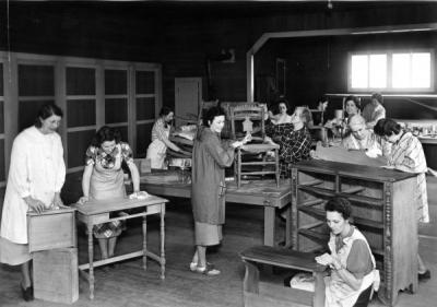 Home Economics students refinishing furniture, 1940s.