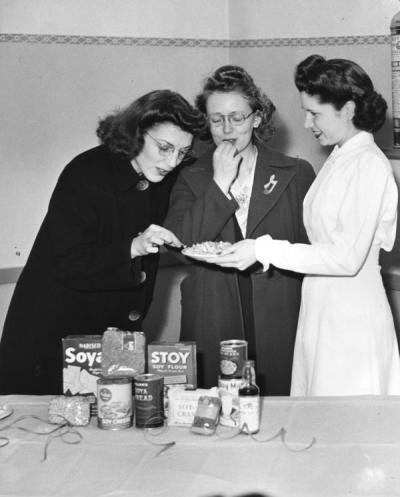 Mary Louise Armstrong (on right) offering a taste of soy foods to two other women, circa 1945. Rainier Vista Cooking School.