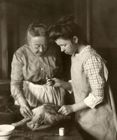 An unidentified woman and girl preparing a goose, 1915.