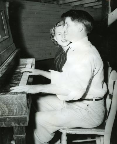 Image annotated: "Morrisen Culver serenading his date, Hawley Hall, 1950-51."
