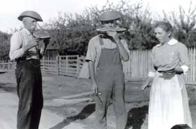 Image from Marie Brady Farm folder annotated: "John, Hilery, and Catherine Gilham standing in Old Pacific Hwy. 99 approx. 1920."