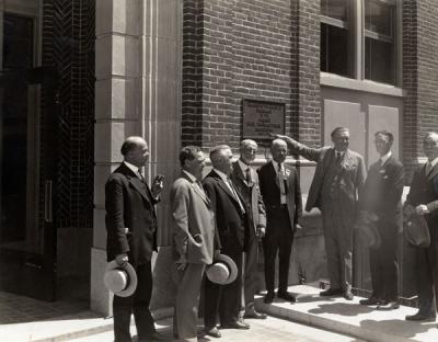 <p>Pharmacy Building dedication, July 1925. Pictured from left to right: E. L. Necomb, F. R. Peterson, Frank S. Ward, William F. Woodward, Pharmacy Dean Adolph Ziefle, A. E. Cosby, H. S. Noel, J. K. Weatherford. Components of</p><p>				the OSC Clippings scrapbooks are believed to have been assembled by Adolph Ziefle.</p>