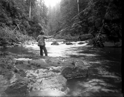 Unidentified man fishing in a stream, ca. 1900s.