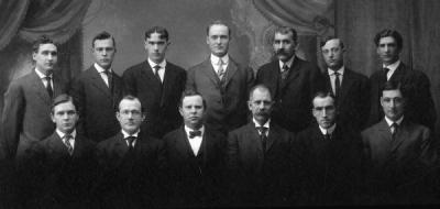 <p>Group photo of the School of Engineering and Mechanic Arts Faculty, 1909. Front row (L to R): Willibald Weniger; Thomas Mooney Gardner; Gordon V. Skelton; Grant Albert Covell; Henry M. Parks; and Mark Clyde Phillips. Back</p><p>				row (L to R): C. L. Knopf; Earl Vincent Hawley; Samuel Herman Graf; E. P. Jackson; William McCaully Porter; Herbert Edward Cooke; and Wilford W. Gardner.</p>
