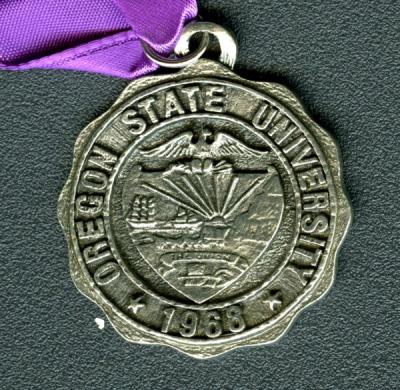Medallion given to Isabella Downs Holt, class of 1916, at her 60th class reunion, 1976.