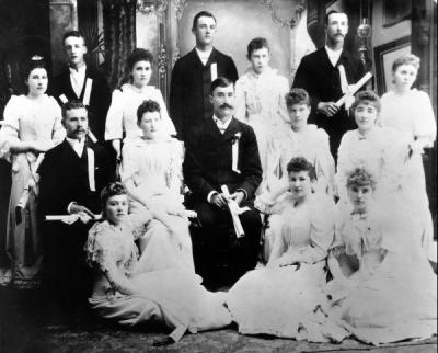 Oregon State College Graduating class of 1892. This class was the first to include home economics graduates. From Left to Right: front row - Lois Stewart Osborn, Martha Avery Fulton, Minnie Waggoner Lilly. Second row - John Fulton, Rose Horton Sheldon, James Storms, Lulu Chandler Eppinger, Leon Louis. Standing - Ida Ray Brandes, Charles Johnson, Nellie Davidson Wattenburg, Richard Scott, Nellie Hogue, Barney S. Martin, Anna Denman.