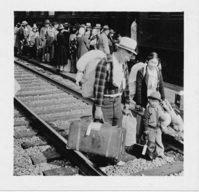 A Japanese family with their luggage, preparing to board an evacuation train, Hood River, Oregon, 1942.