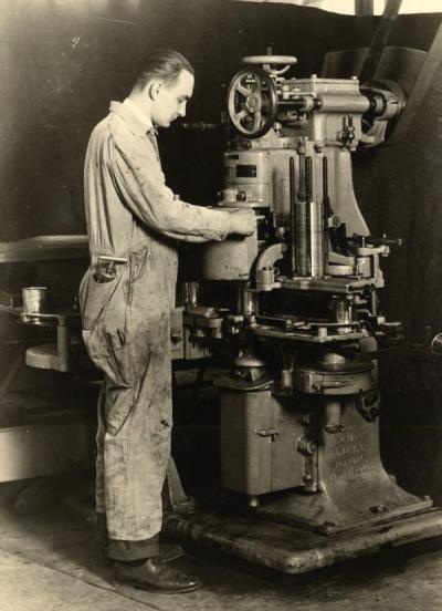 An unidentified man adjusting a Canco Machine at the OSC Canners Short Course, ca. 1930.