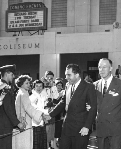 Vice President Richard Nixon shaking hands outside Gill Coliseum, escorted by John Gallagher, Fall 1954.