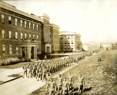 Oregon Agricultural College ROTC students marching adjacent to the Agriculture Building, ca. 1917-1918.