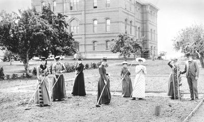 Women working in vegetable garden with Professor George Coote