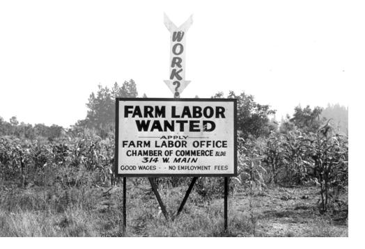 Photo of a billboard reading 'Farm Labor Wanted'